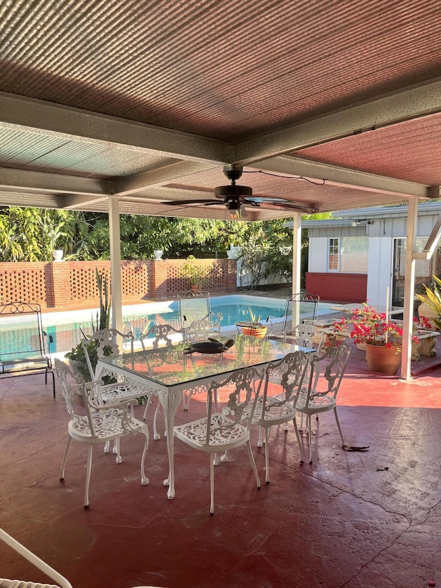 view of patio / terrace featuring a fenced in pool and ceiling fan