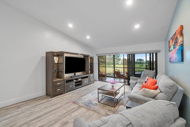 living room with a textured ceiling, light hardwood / wood-style flooring, and high vaulted ceiling