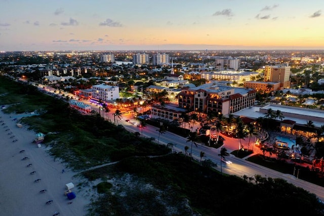 aerial view at dusk featuring a water view