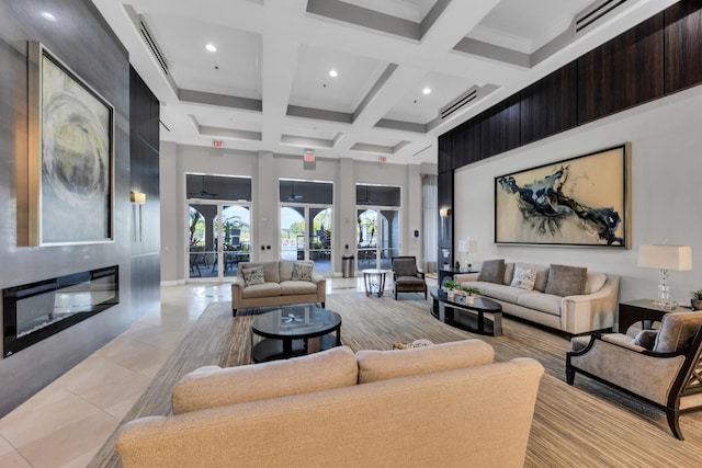 tiled living room with beam ceiling, a large fireplace, a towering ceiling, and coffered ceiling