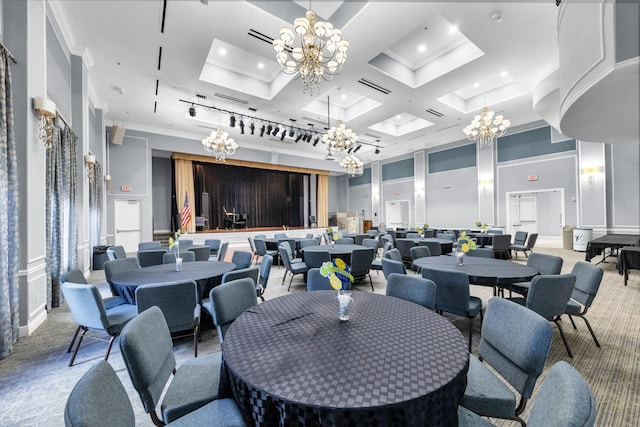 carpeted dining room featuring crown molding, a towering ceiling, a chandelier, and coffered ceiling