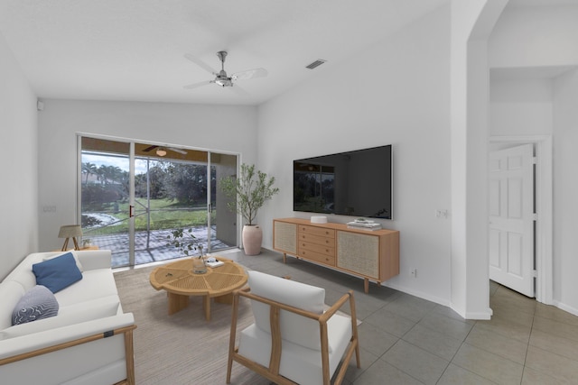 tiled living room featuring ceiling fan and vaulted ceiling