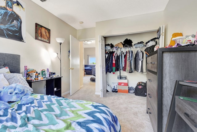 carpeted bedroom featuring a textured ceiling and a closet