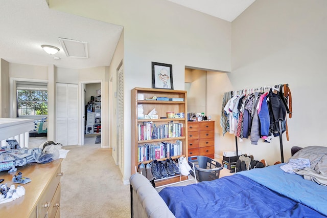 carpeted bedroom with a textured ceiling and two closets