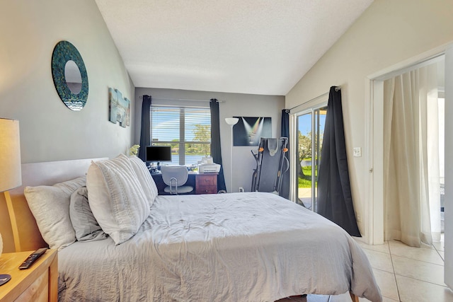 bedroom featuring a textured ceiling, light tile patterned flooring, and lofted ceiling