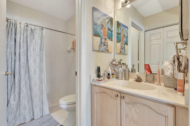 bathroom featuring a shower with shower curtain, vanity, toilet, and tile patterned flooring