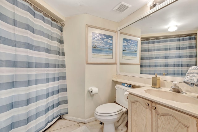 bathroom featuring tile patterned flooring, vanity, and toilet