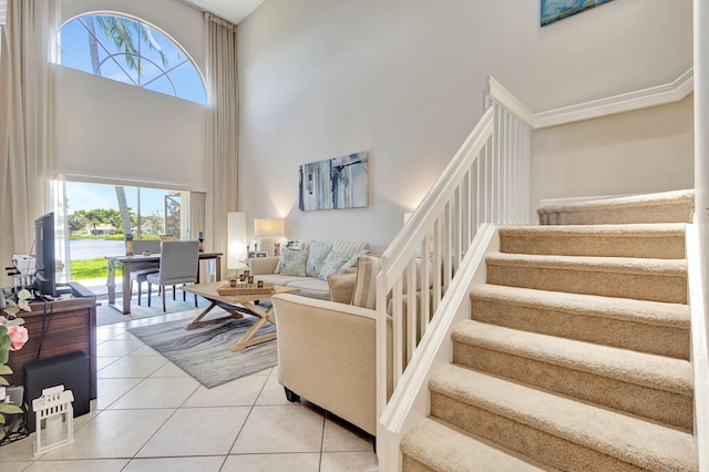 living room with tile patterned flooring and a high ceiling