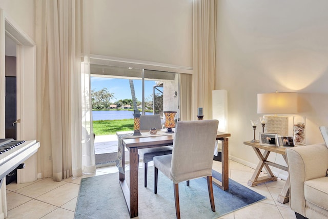 tiled dining area featuring a water view