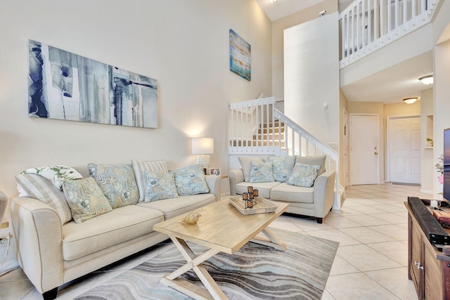 tiled living room featuring a high ceiling