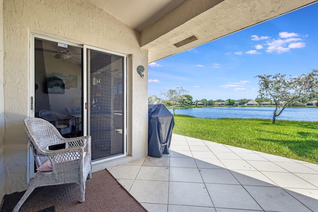 view of patio with a water view and area for grilling