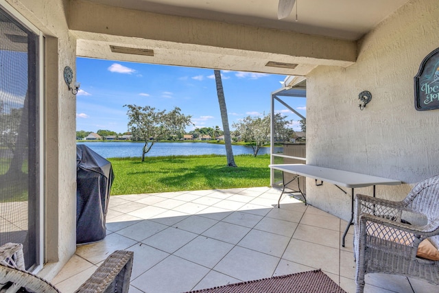 sunroom featuring a water view