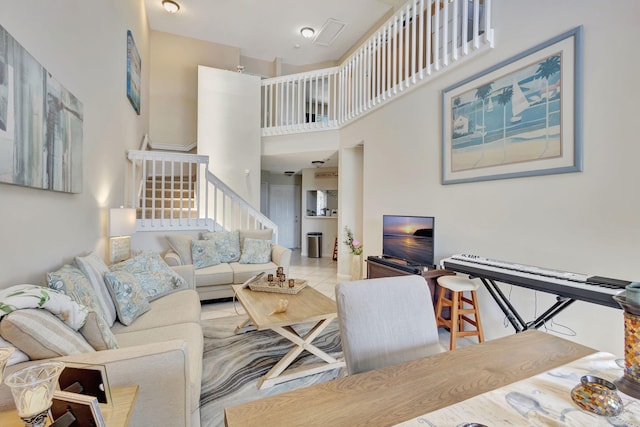 tiled living room with a high ceiling