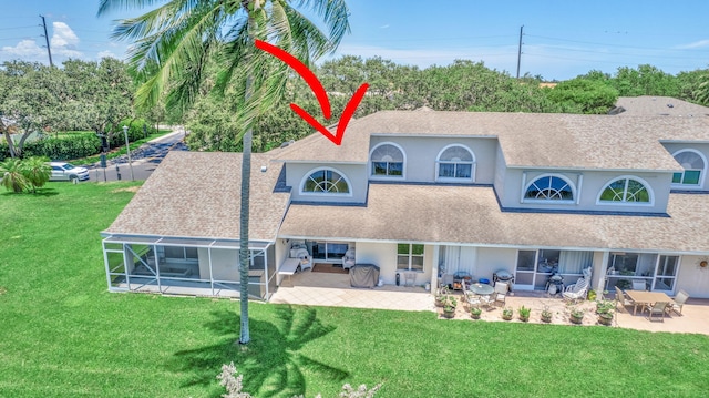 back of house with a patio and a lawn