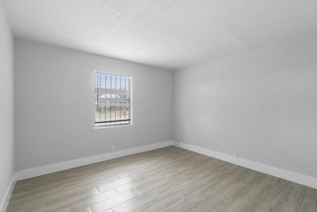 empty room with light hardwood / wood-style flooring