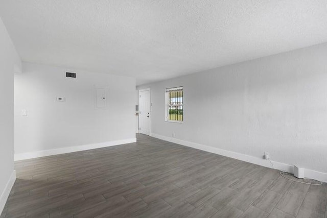 unfurnished room with dark hardwood / wood-style floors