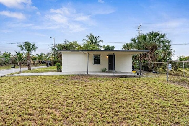 rear view of property featuring a lawn