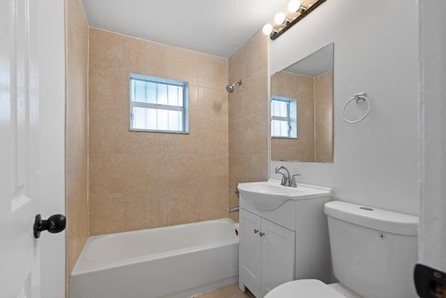 full bathroom with vanity, toilet, and tiled shower / bath combo