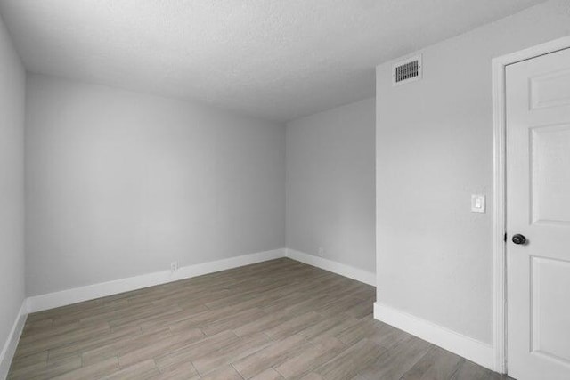 spare room featuring light wood-type flooring