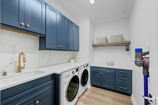 washroom with cabinets, independent washer and dryer, light wood-type flooring, ornamental molding, and sink