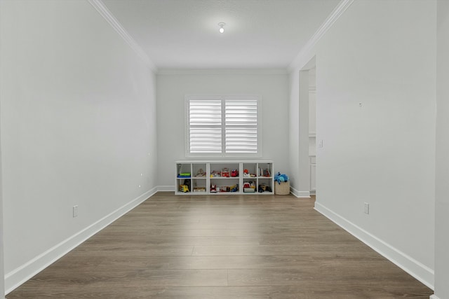 unfurnished room featuring wood-type flooring and ornamental molding