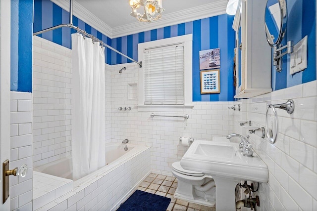 bathroom featuring an inviting chandelier, tile patterned floors, crown molding, toilet, and shower / bath combo with shower curtain