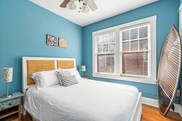 bedroom with ceiling fan and wood-type flooring