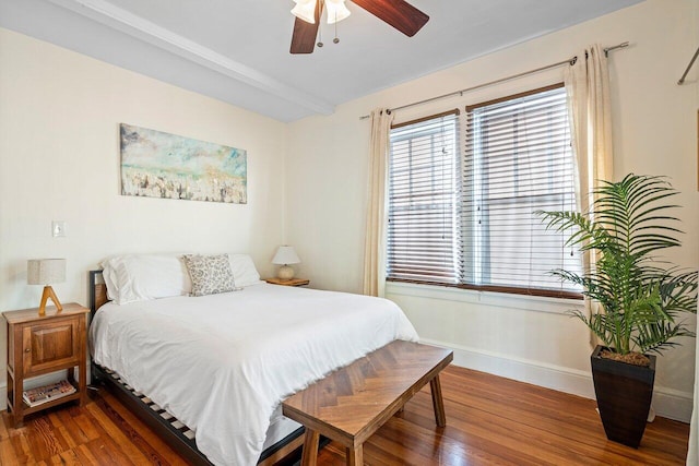 bedroom with beamed ceiling, dark hardwood / wood-style flooring, and ceiling fan