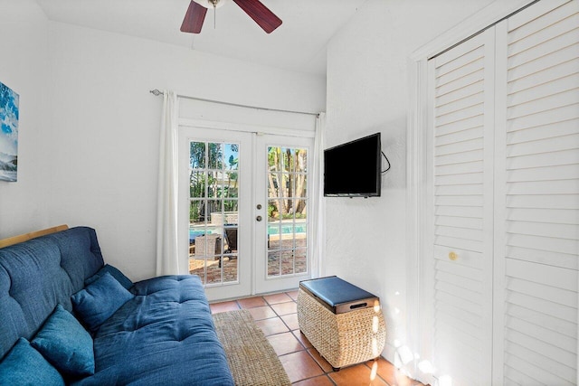 tiled living room featuring ceiling fan and french doors