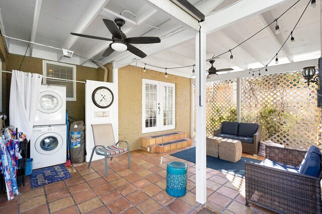 view of patio with an outdoor living space, ceiling fan, stacked washer / dryer, and french doors