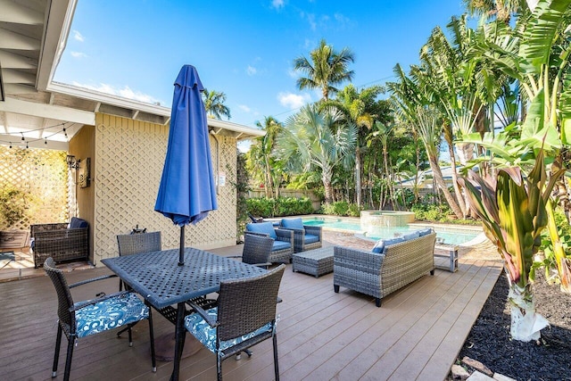 wooden deck featuring a swimming pool with hot tub