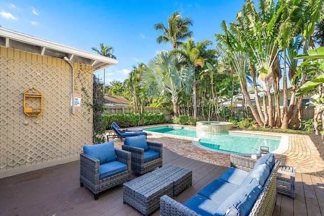 view of pool featuring an in ground hot tub and a deck