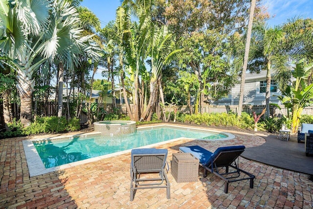 view of swimming pool featuring an in ground hot tub