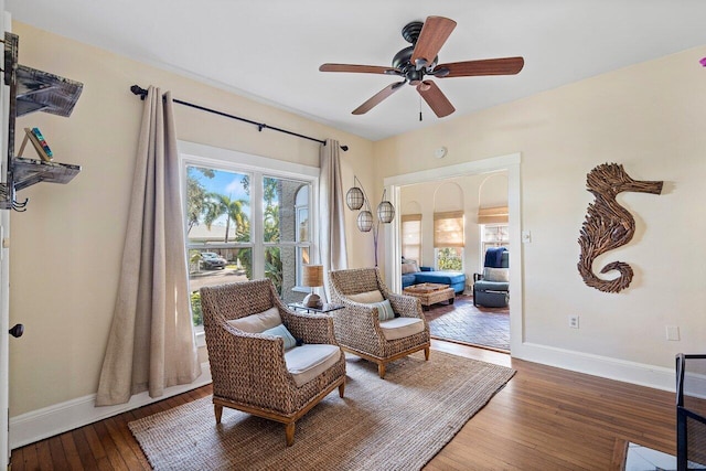 living area featuring ceiling fan and wood-type flooring