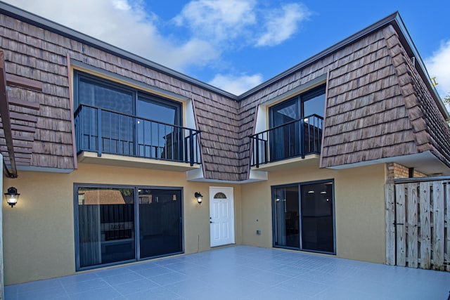 rear view of property featuring a patio area