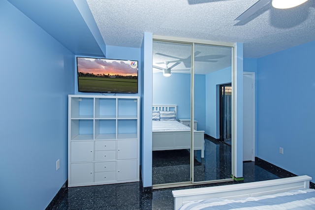 unfurnished bedroom with a textured ceiling, ceiling fan, and a closet