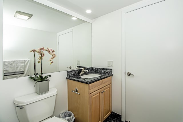 bathroom featuring toilet and vanity