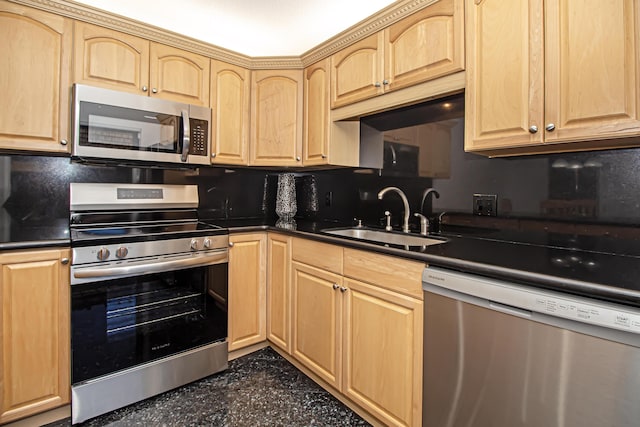 kitchen featuring appliances with stainless steel finishes, light brown cabinetry, and sink