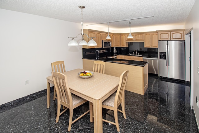 dining room featuring a textured ceiling and sink