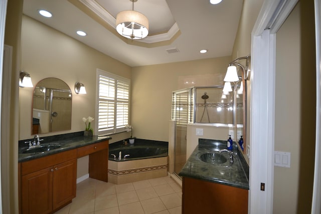 bathroom with plus walk in shower, vanity, a tray ceiling, and tile patterned flooring