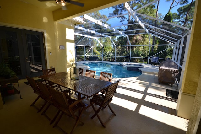 view of pool with a lanai, a patio area, and an in ground hot tub