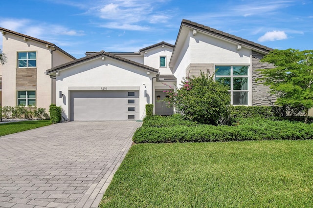 view of front of property featuring a garage and a front lawn