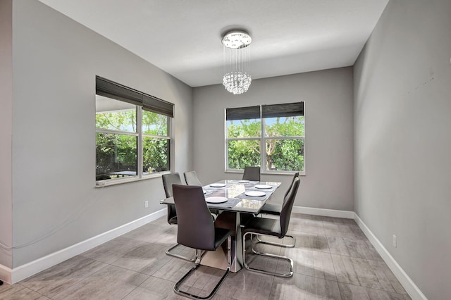 dining area with a healthy amount of sunlight and a notable chandelier