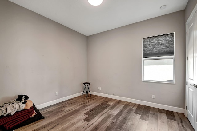 empty room with wood-type flooring