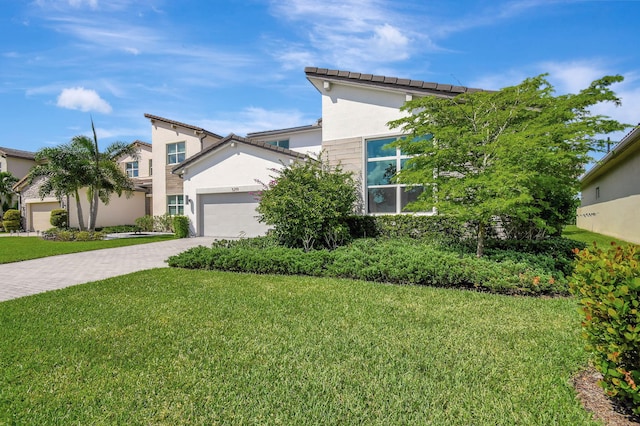 view of front of property featuring a garage and a front lawn