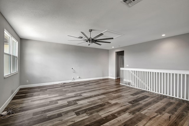 spare room with a textured ceiling, dark hardwood / wood-style floors, and ceiling fan