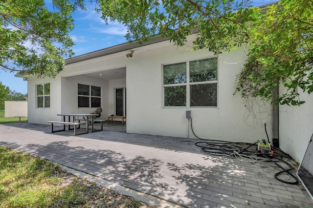 rear view of house with a wooden deck