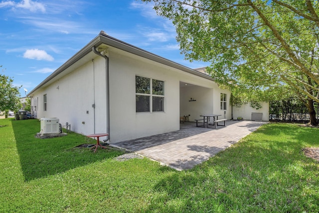 back of house featuring a yard and a patio area