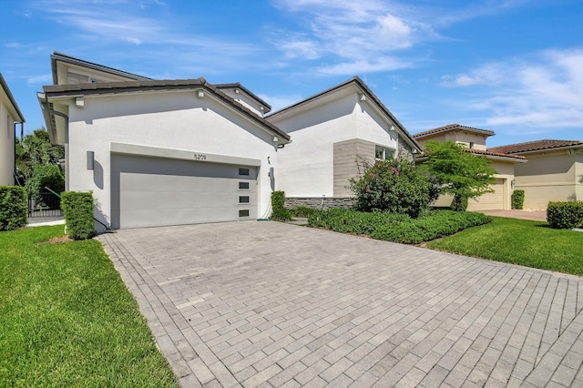 view of front of property with a garage and a front yard