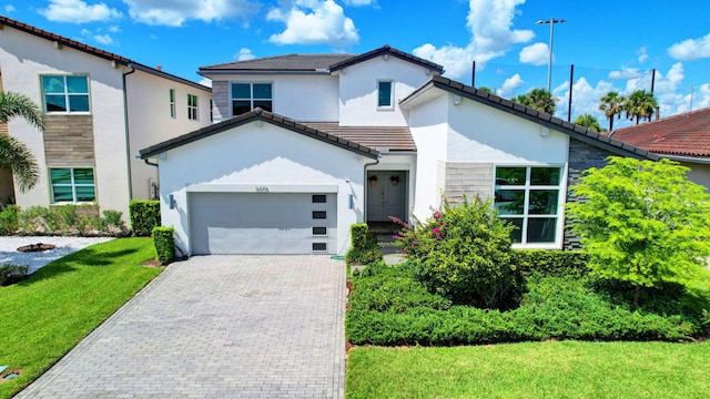 view of front of house with a garage and a front yard